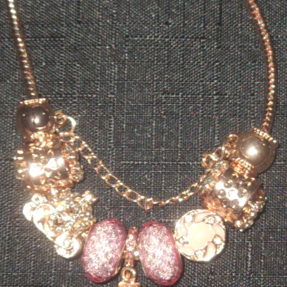 Gold and Pink Charm Bracelet with Ornate Charms. ITEM No. 19-144